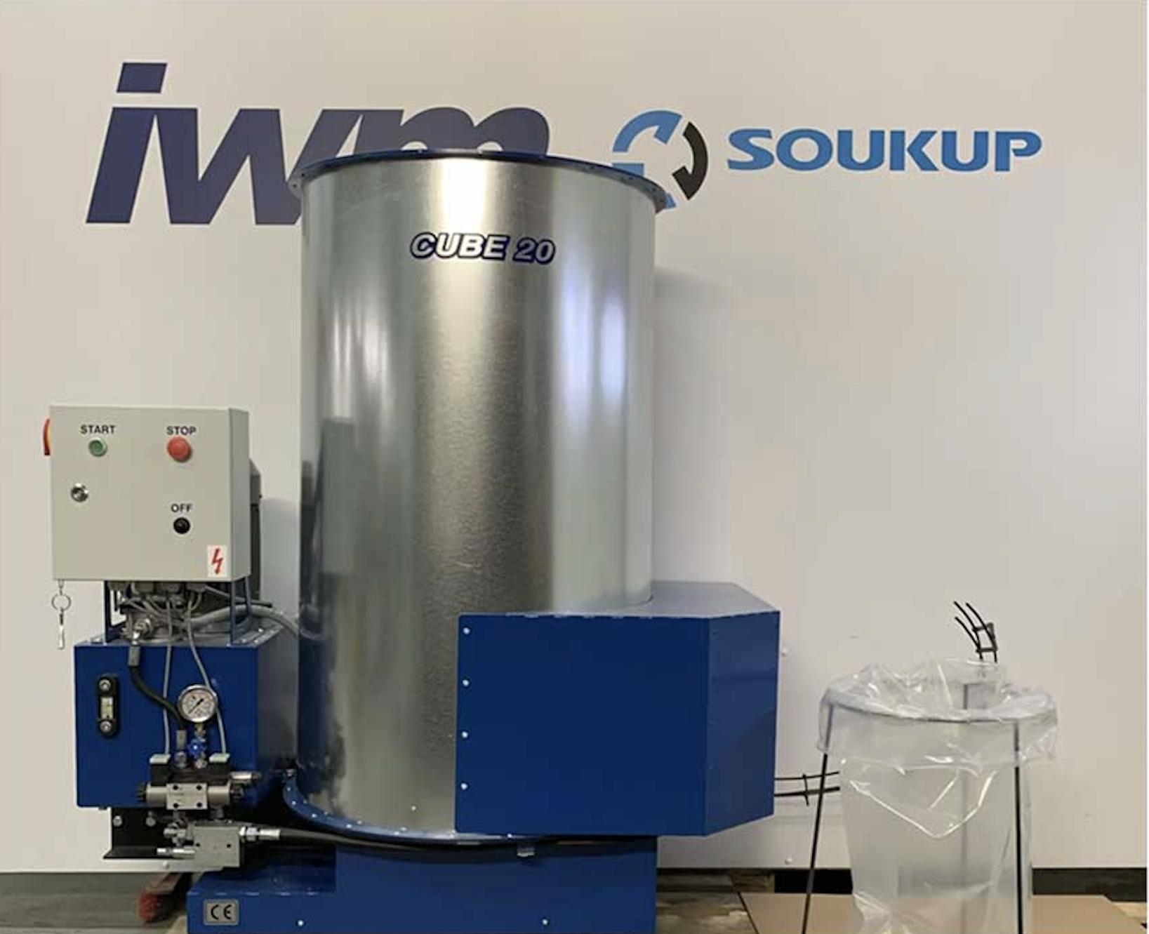 IWM Soukup Cube 20 briquette machine with blue base, stainless steel drum, and control panel with start and stop buttons