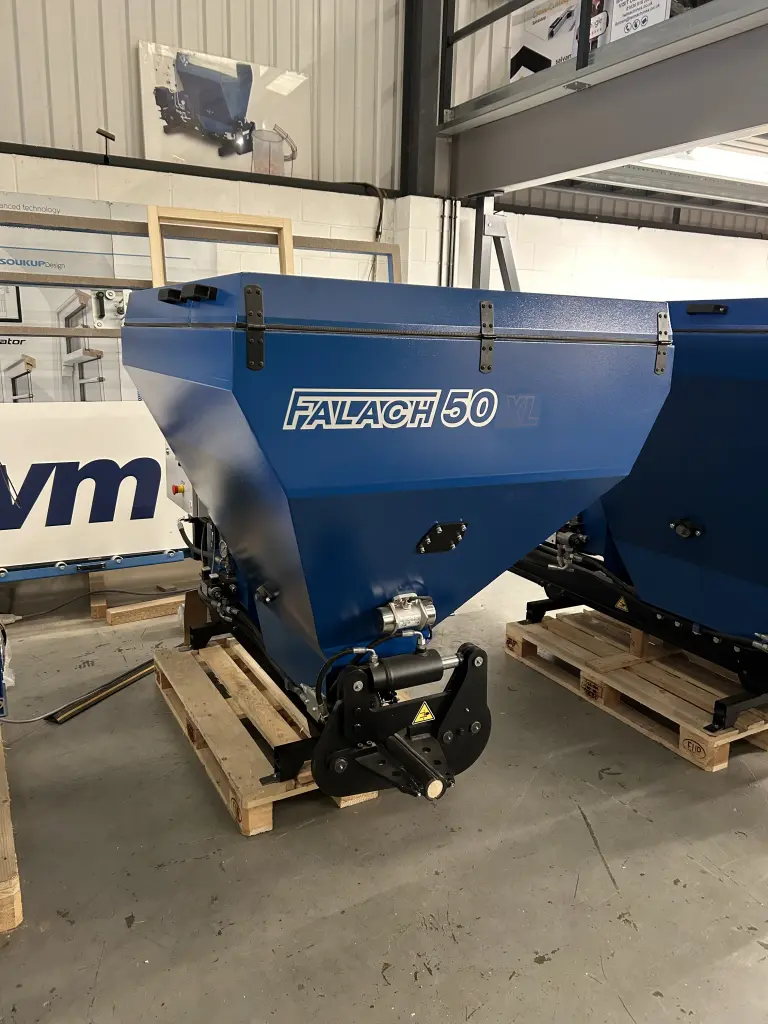 Falach 50XL blue briquette machine on a wooden pallet inside a warehouse