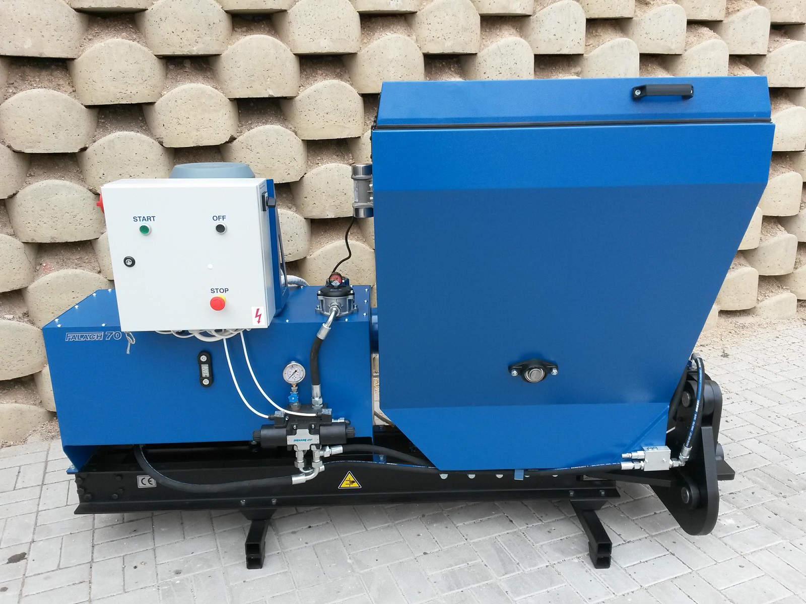 Falach 70 briquette machine in blue with a white control panel featuring start, stop and off buttons, mounted on a black steel frame