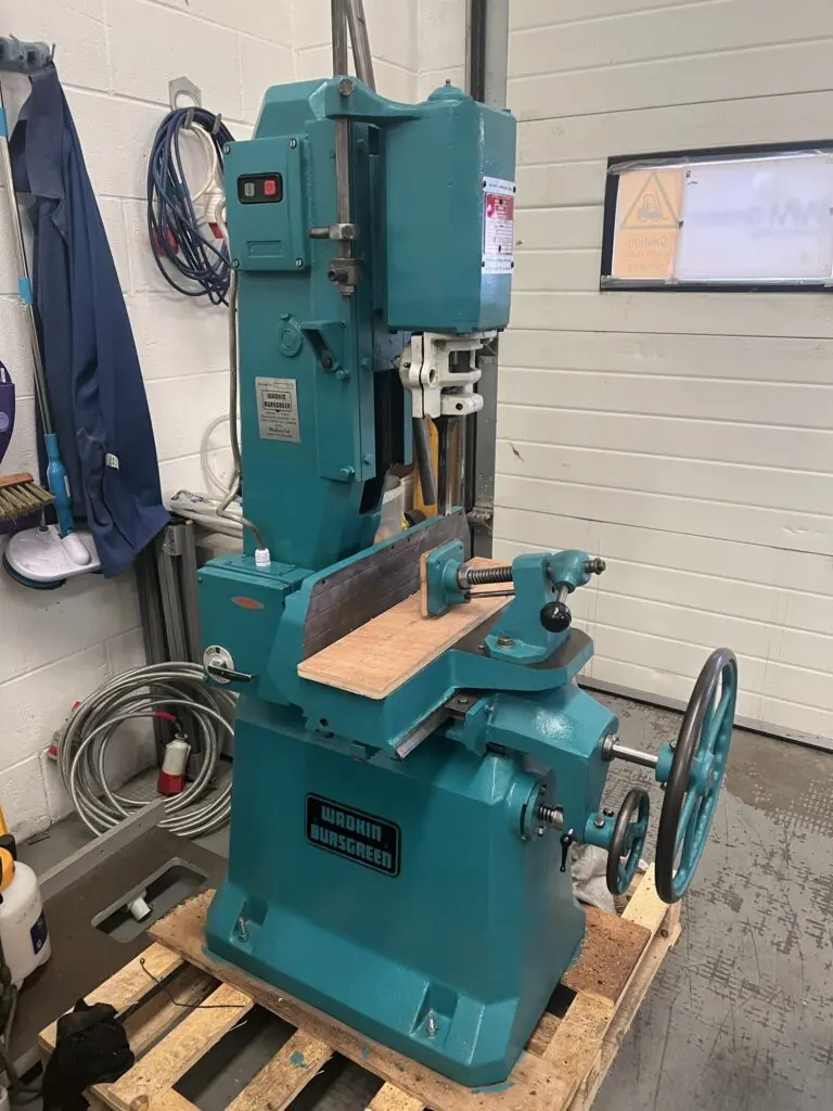 Fully refurbished teal Wadkin Bursgreen vibrating chisel mortiser on a wooden pallet in a workshop