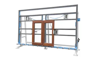Soukup GW 2500 mounting and glazing stand holding a brown double door frame with blue clamps