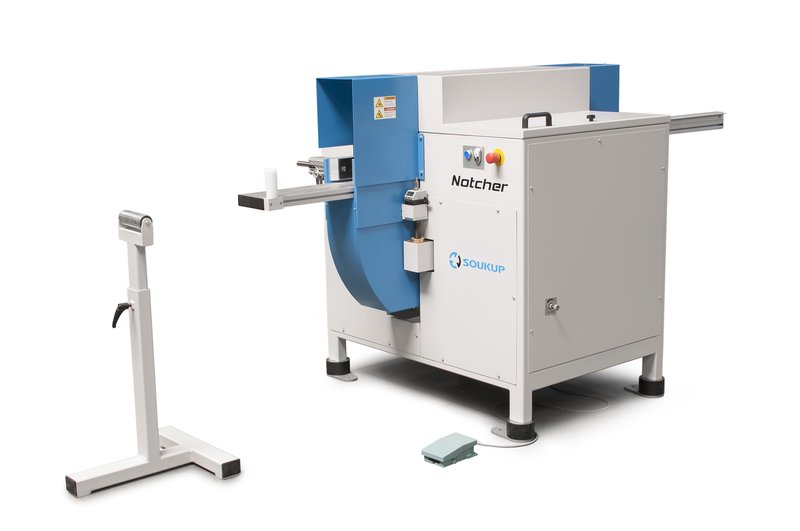 Soukup Notcher machine in grey and blue with extended material supports, foot pedal, and emergency stop button