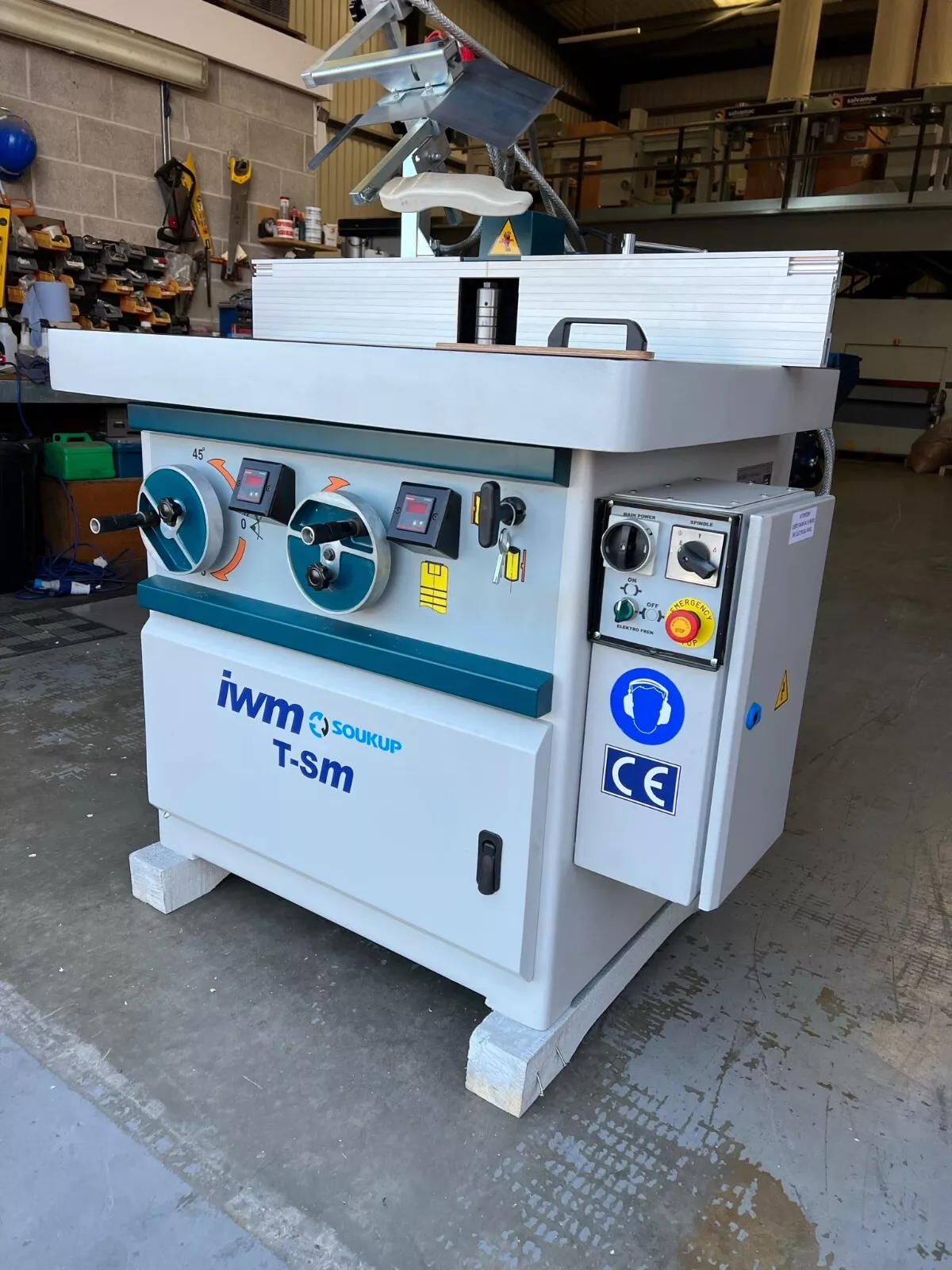 IWM Soukup T-Sm tilting spindle moulder with control panel, emergency stop button, and CE marking, in a workshop